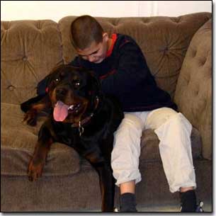 Rottie-Gabriel and KC happy petting Gabriel on couch