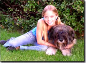Briard-Artemis with Co-Star Emily laying on grass
